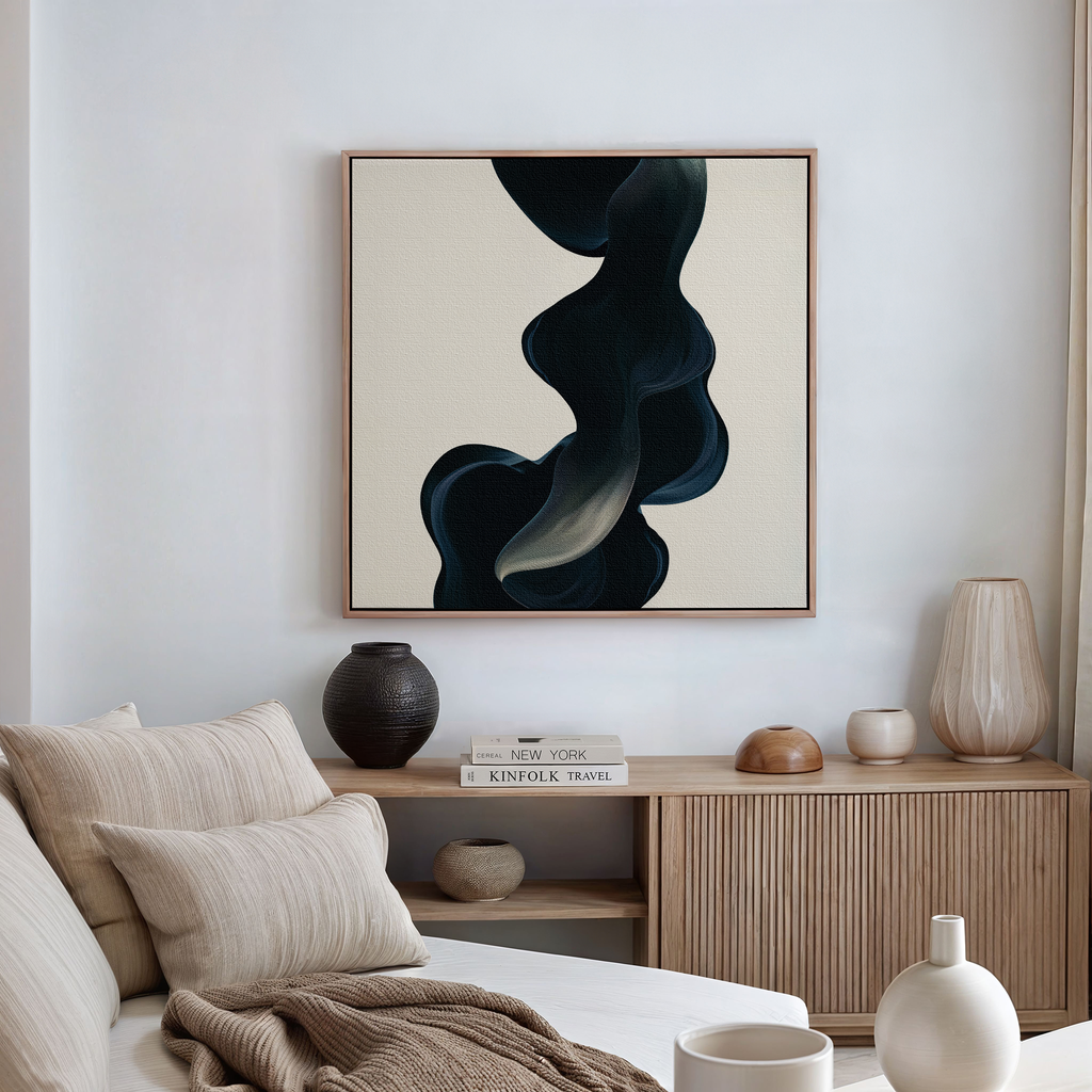 A modern living room features a light sofa with beige cushions, a wooden sideboard with decorative vases, and the Nocturnal Wave Abstract Canvas Art—a striking piece with dark swirling shapes on a light background—completing the decor.