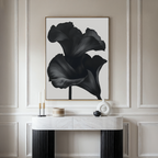 A modern interior showcases a marble console with decorative accents beneath the Noir Bloom Abstract Canvas Art featuring black abstract flowers, all set against an elegant beige paneled wall—perfect for elevated living room decor.