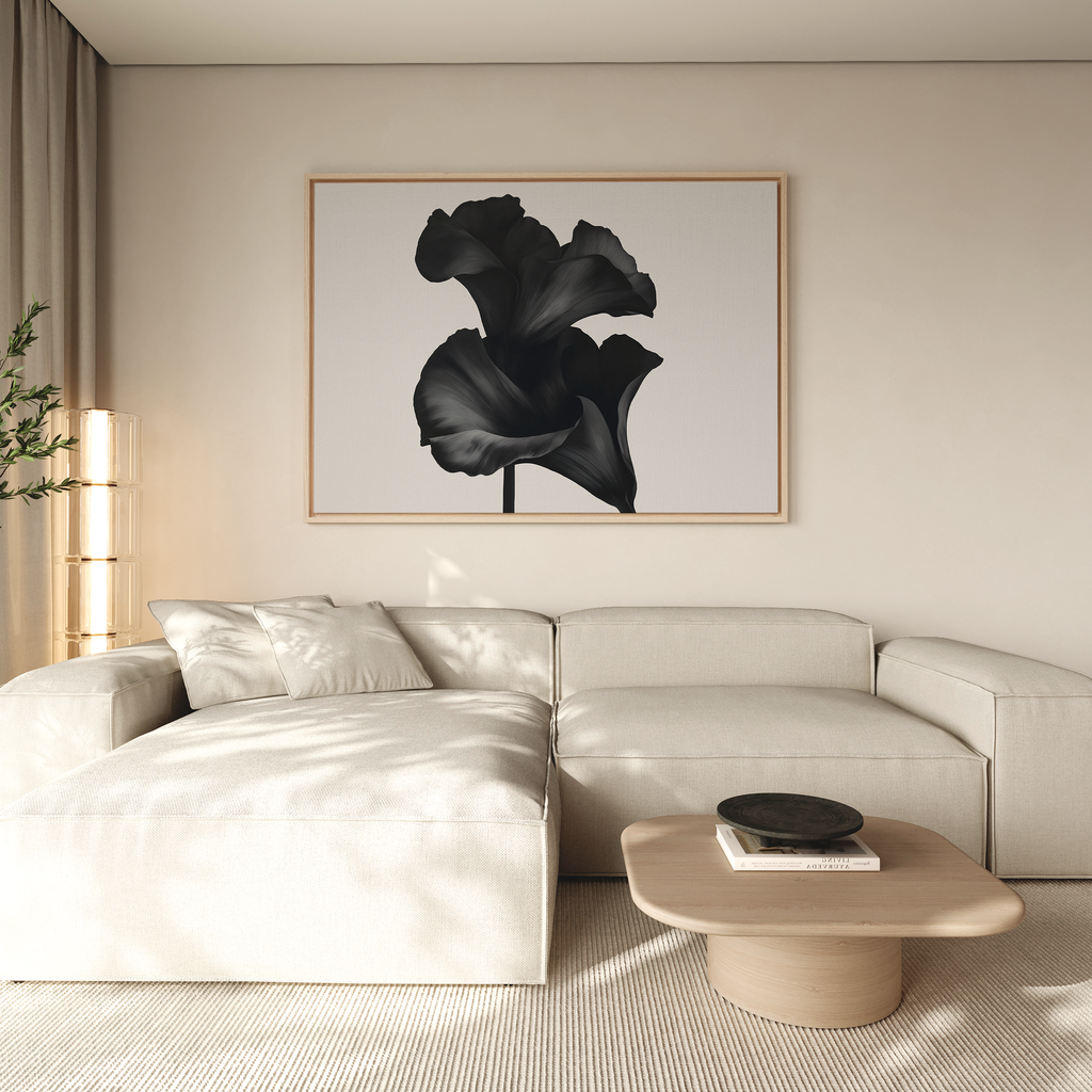 A modern living room with a cream sectional, light wood coffee table, and the Noir Bloom Canvas Art – Horizontal as large framed black wall art, featuring neutral tones and minimalist decor.