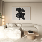 A modern living room with a cream sectional, light wood coffee table, and the Noir Bloom Canvas Art – Horizontal as large framed black wall art, featuring neutral tones and minimalist decor.