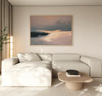 Minimalist living room featuring a light beige sectional, low wooden coffee table with black bowl, tall plant, and the Nordic Fjord Canvas Art - Horizontal—a large abstract landscape in soft tones—hanging above the sofa.