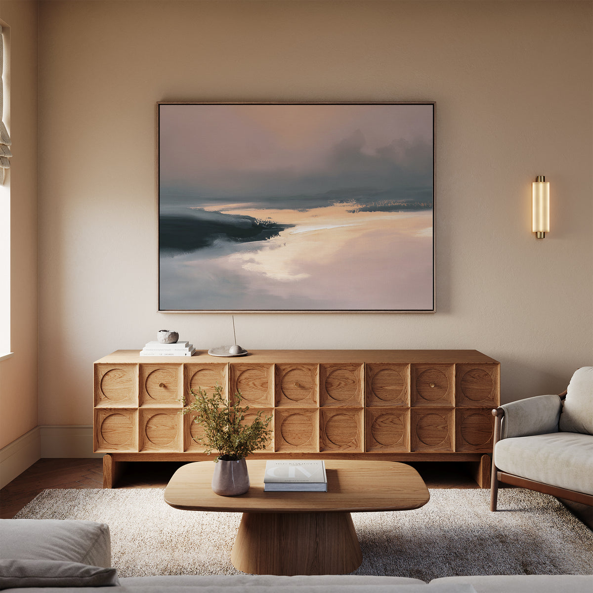 A modern living room features the Nordic Fjord Canvas Art - Horizontal above a wooden sideboard, complemented by a beige sofa, a wooden coffee table with a vase of flowers, and soft neutral tones throughout the decor.