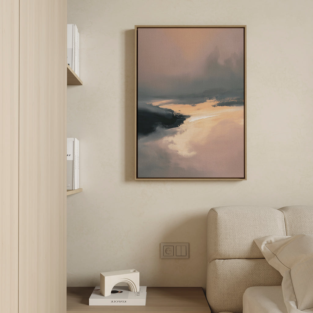 A modern living room features a beige sofa, a small shelf with books and decor, and the Nordic Fjord Canvas Art - Vertical, a framed landscape print in warm and dark tones displayed on a light-colored wall.