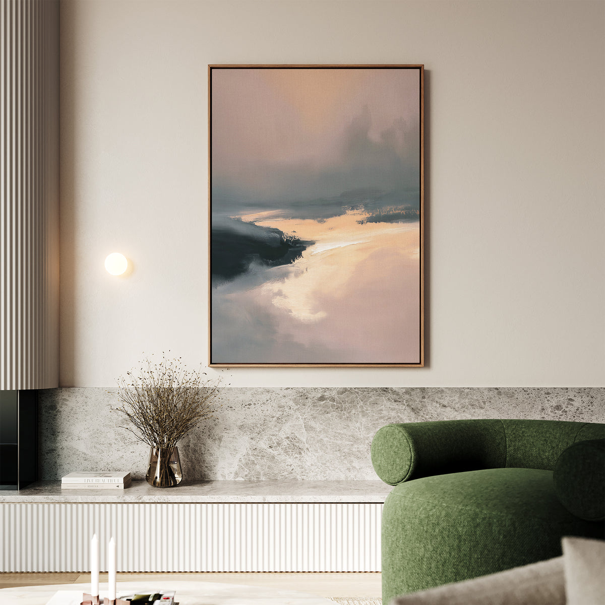 A modern living room showcases the Nordic Fjord Canvas Art - Vertical, featuring soft pink, peach, and dark blue tones above a marble-topped shelf, with a green curved sofa, round wall light, and a vase of dried flowers.