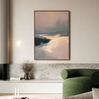 A modern living room showcases the Nordic Fjord Canvas Art - Vertical, featuring soft pink, peach, and dark blue tones above a marble-topped shelf, with a green curved sofa, round wall light, and a vase of dried flowers.
