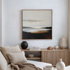 A neutral-toned living room features a beige sofa, cream pillows, a wooden sideboard with books and vases, and calming decor highlighted by the Nordic Waters Canvas Art - Square. Sheer curtains let in gentle natural light.