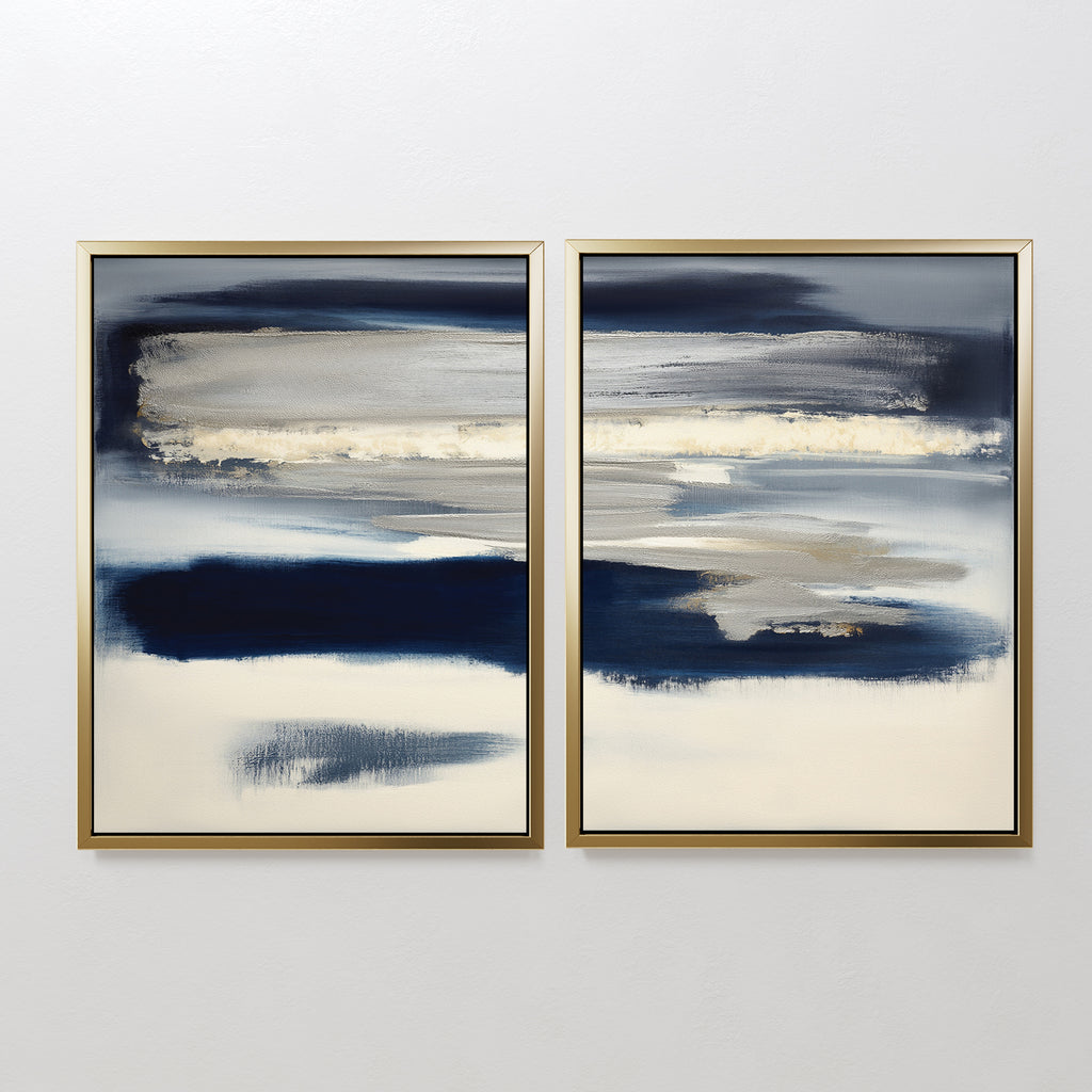 Northern Tides - Set Of 2 features abstract prints with horizontal navy, gray, beige, and white brushstrokes in minimalist style, each framed in slim gold frames and displayed side by side against a plain white wall.