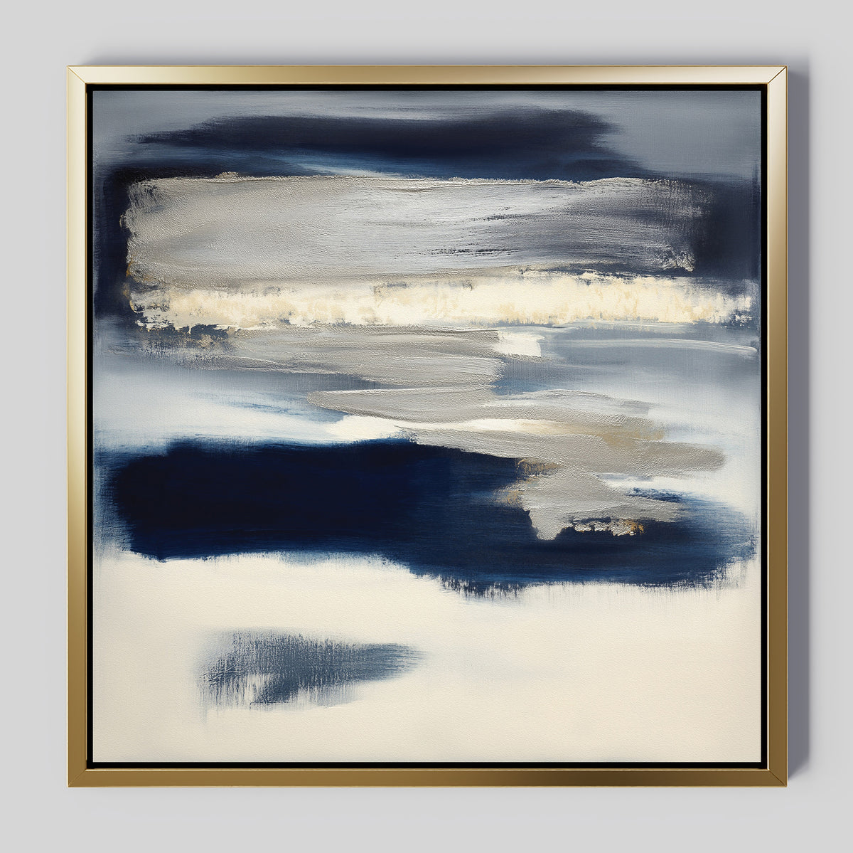 Northern Tides Canvas Art - Square features bold indigo blue, white, and cream brushstrokes for a layered, cloudy look. This contemporary abstract print comes framed in a thin gold metallic frame with a light gray background.