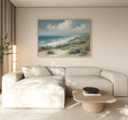 A living room featuring the Ocean Bluff Canvas Art - Horizontal as a large coastal scene painting on the wall.