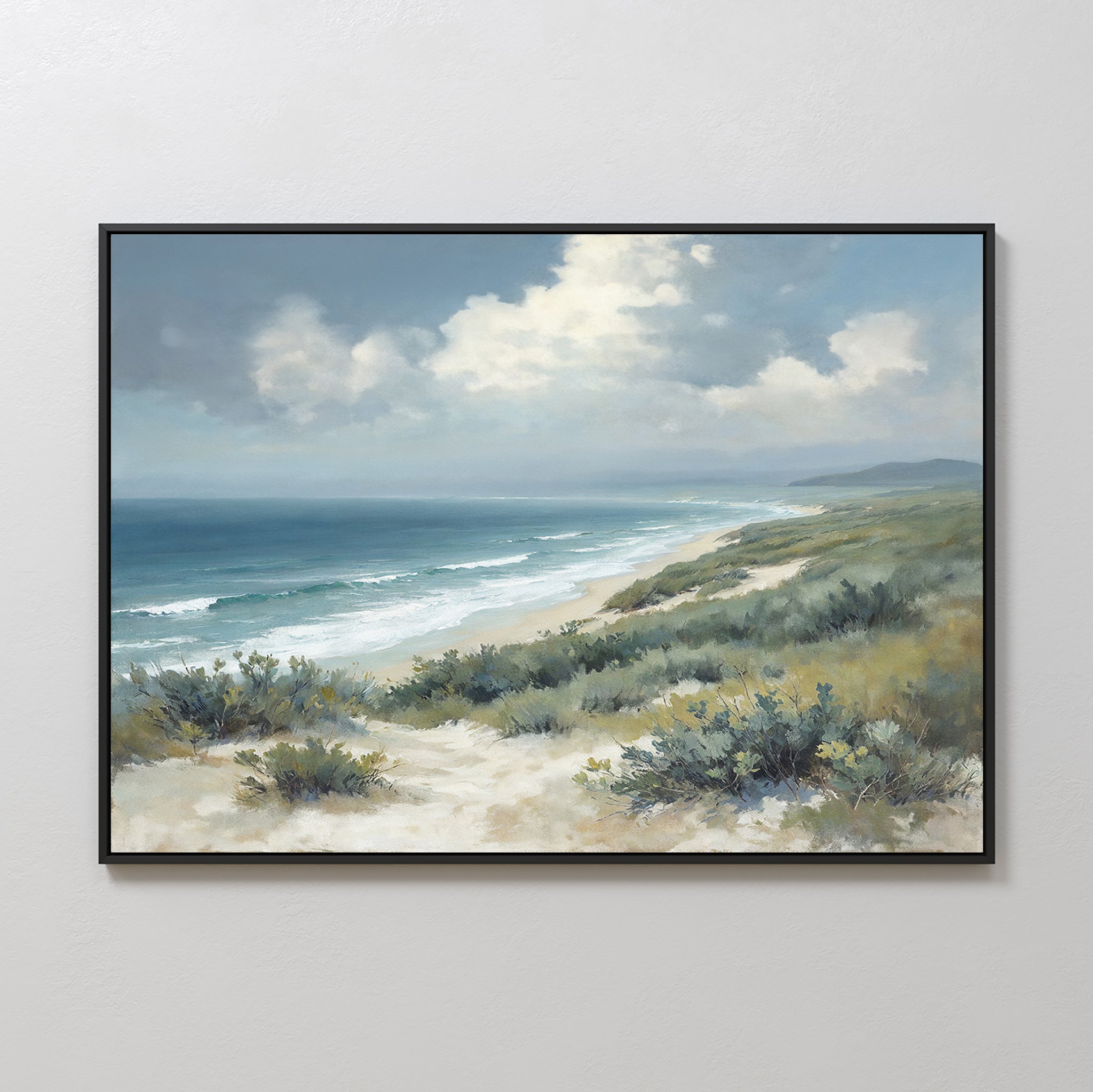 The Ocean Bluff Canvas Art - Horizontal features a coastal scene with sandy dunes, sparse vegetation, rolling waves, and a cloudy blue sky above the ocean shore in a framed canvas print.