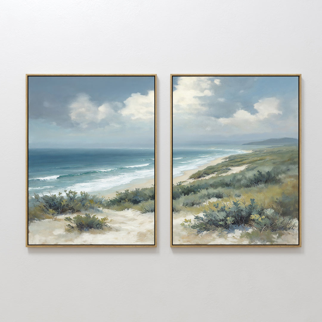 The Ocean Bluff - Set of 2 features framed canvas prints showing sandy dunes, lush green shrubs, and ocean waves beneath a partly cloudy sky, capturing the serene beauty of a coastal landscape.