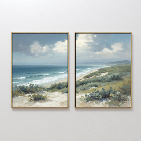 The Ocean Bluff - Set of 2 features framed canvas prints showing sandy dunes, lush green shrubs, and ocean waves beneath a partly cloudy sky, capturing the serene beauty of a coastal landscape.