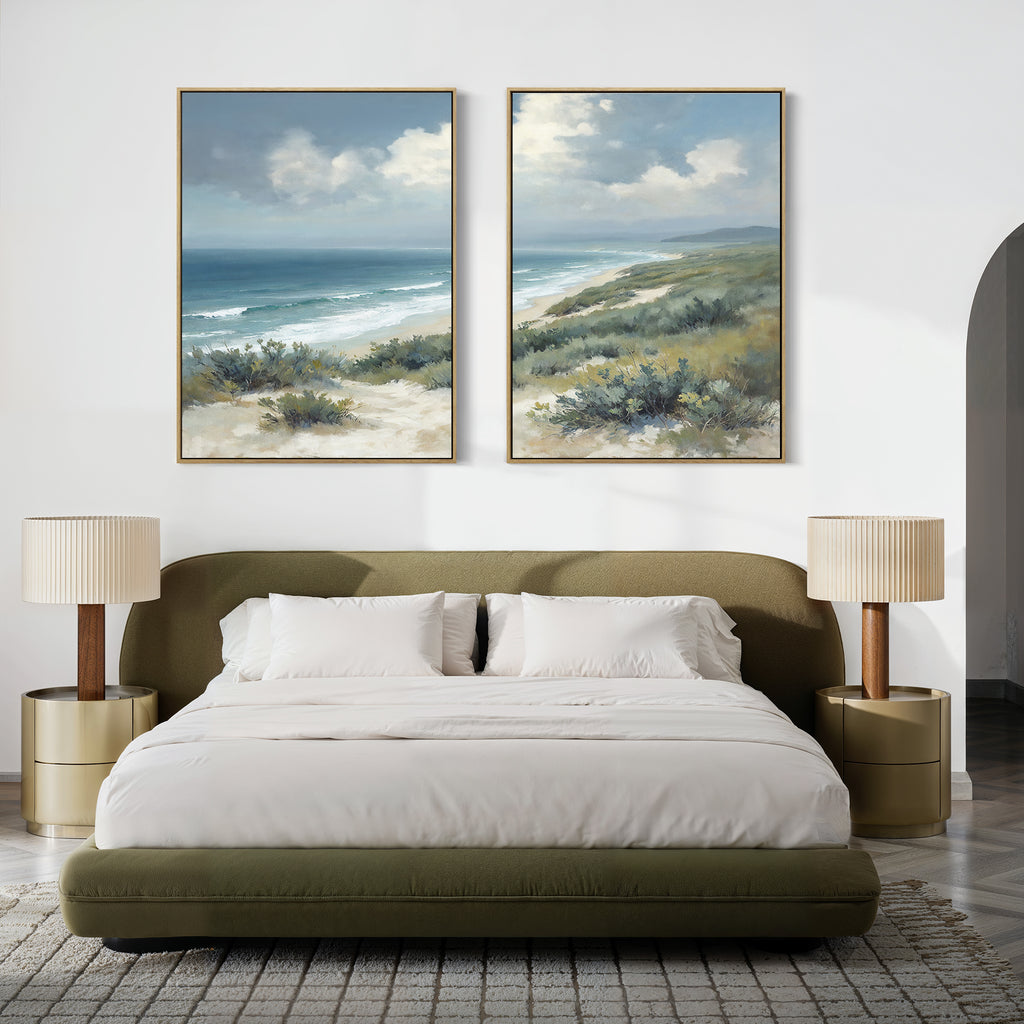A modern bedroom with an olive green bed, white bedding, two beige nightstands with matching lamps, and Ocean Bluff - Set of 2 large seaside canvas prints above the headboard.