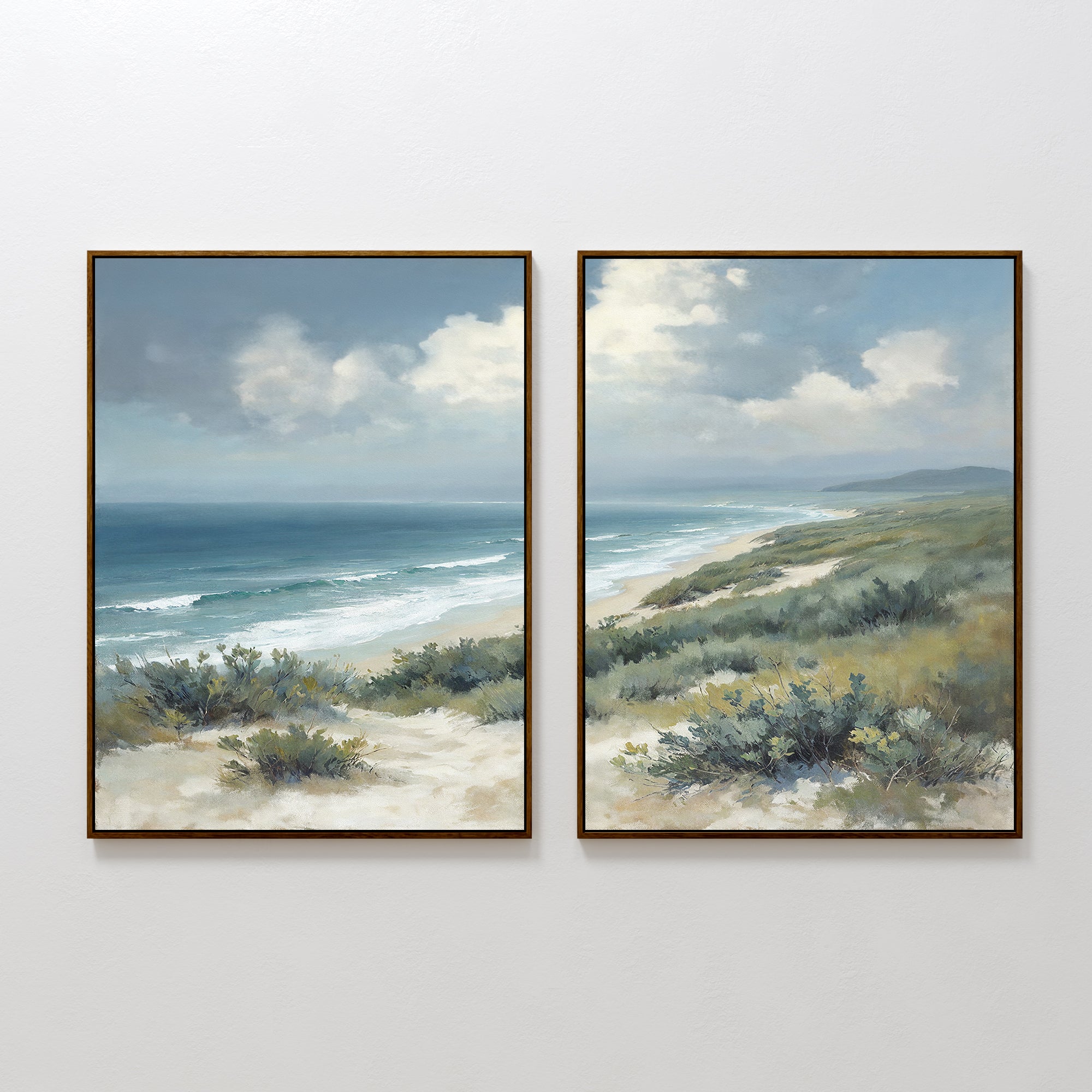 The Ocean Bluff - Set of 2 features framed paintings of a coastal scene with dunes, shrubs, blue ocean waves, and a cloudy sky. The left print emphasizes the water, while the right focuses on the shoreline and horizon.