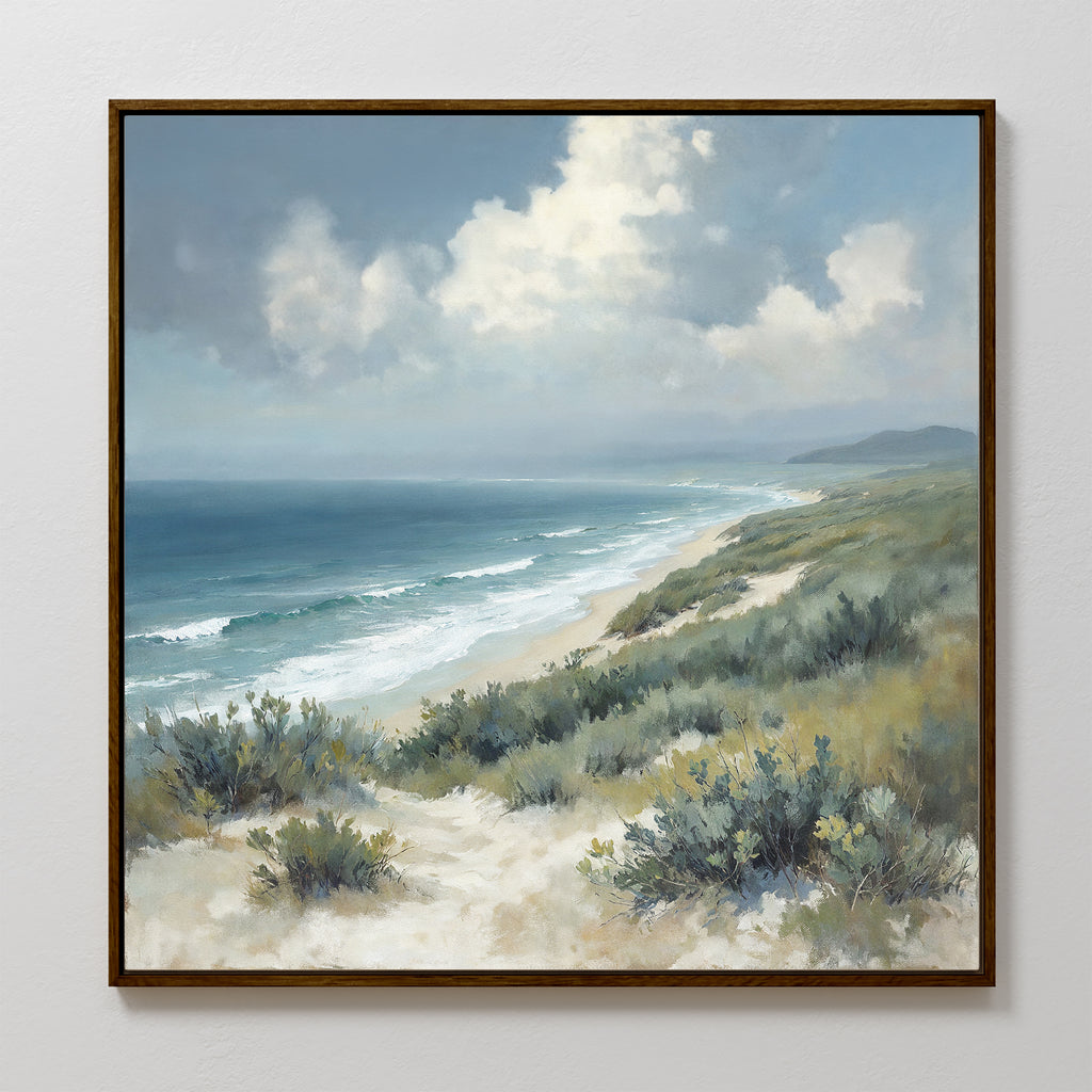 Ocean Bluff Canvas Art - Square showcases waves hitting a sandy shore with dunes and green shrubs below a blue, partly cloudy sky. Distant hills line the horizon—ideal for Nordic Park-inspired coastal decor.