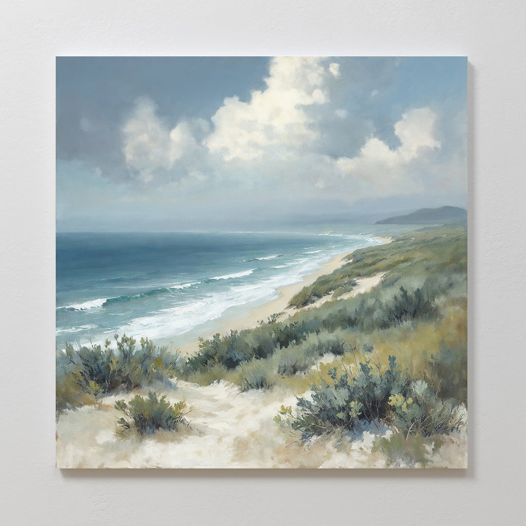 Ocean Bluff Canvas Art - Square features a serene seaside scene with a sandy beach, gentle waves, lush greenery, and a partly cloudy sky—perfect for adding coastal tranquility to your space.