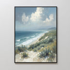 The Ocean Bluff Canvas Art - Vertical features sandy dunes and green shrubs in the foreground, waves on a blue ocean, and a cloudy sky above with faint distant mountains, creating serene coastal wall art.