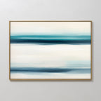 Ocean Motion Canvas Art - Horizontal features softly blended blue, teal, and white bands for a serene coastal feel. Displayed in a thin gold frame on a light wall, it brings sophisticated tranquility to any space.