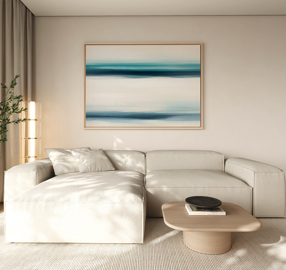 A modern living room features a light beige sectional, wooden coffee table, and the Ocean Motion Canvas Art - Horizontal. Soft natural light through beige curtains enhances the tranquil ambiance and serene sophistication of the space.