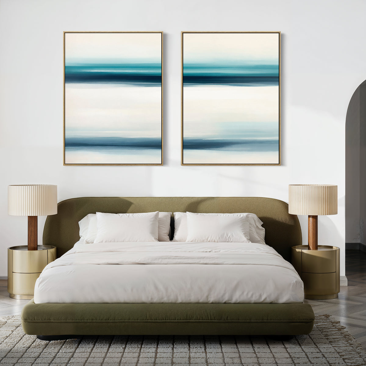 A modern bedroom with a green upholstered bed, white bedding, beige nightstands with matching lamps, and the Ocean Motion - Set Of 2 blue and white paintings above the headboard exudes serene sophistication.