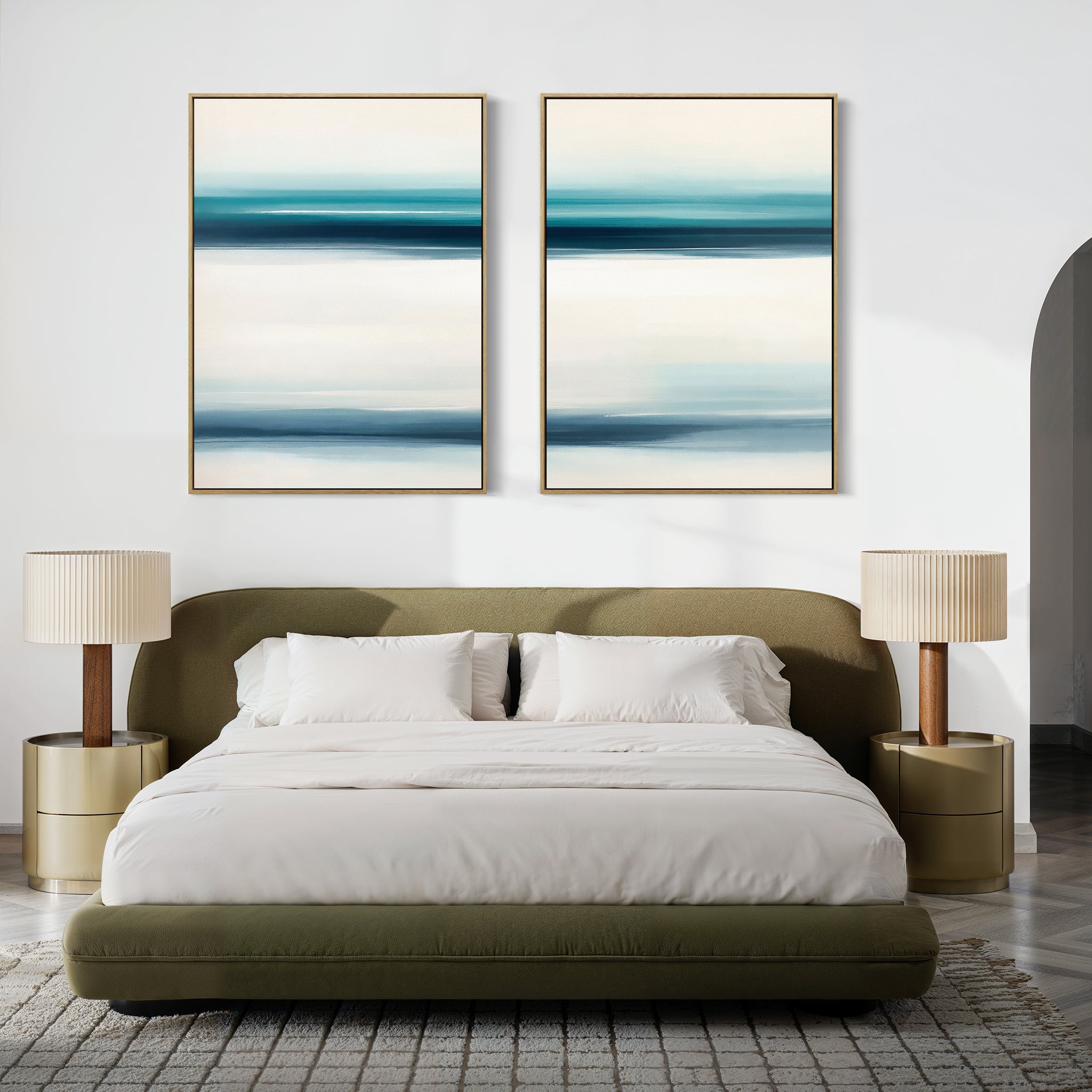 A modern bedroom with a green upholstered bed, white bedding, beige nightstands with matching lamps, and the Ocean Motion - Set Of 2 blue and white paintings above the headboard exudes serene sophistication.