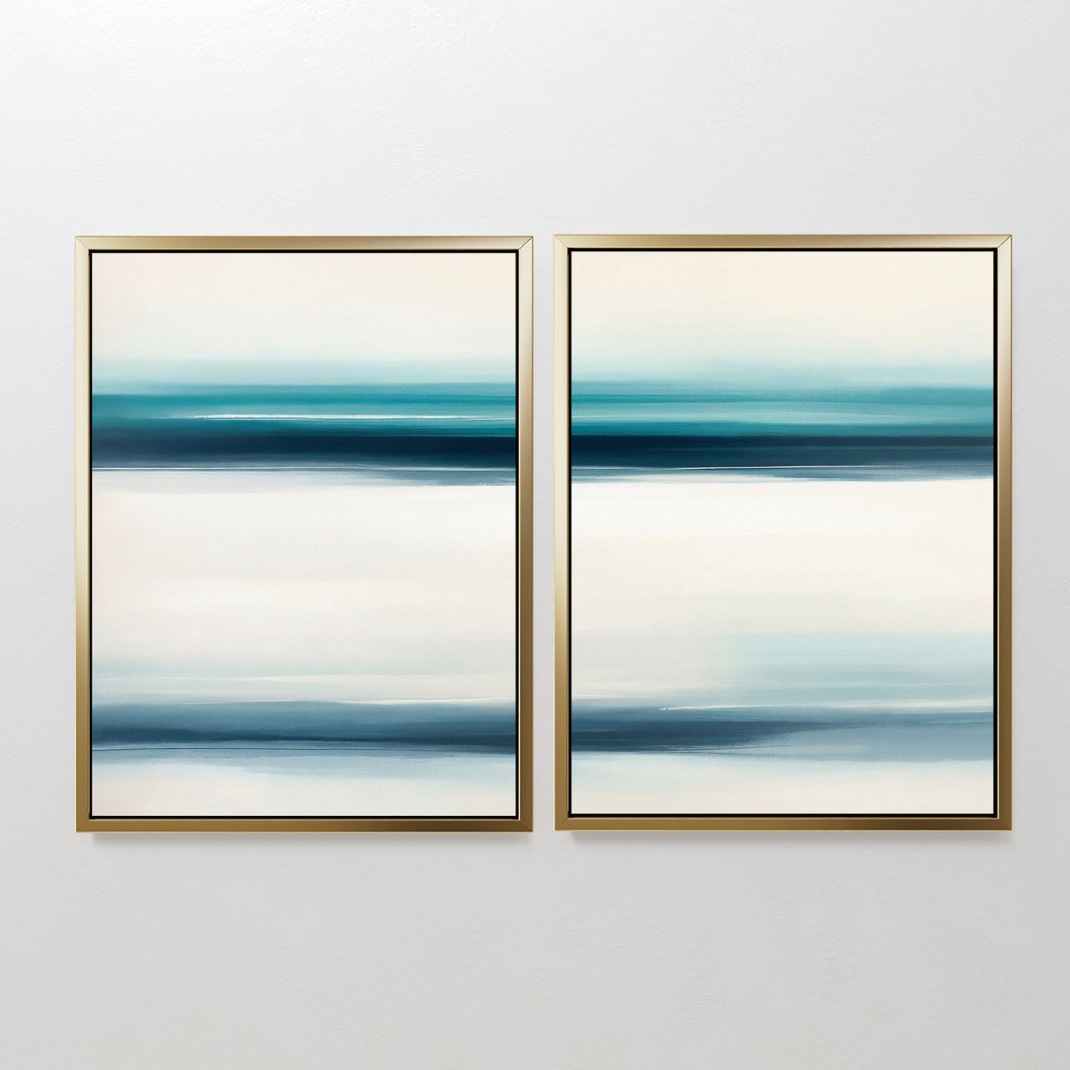 The Ocean Motion - Set Of 2 features abstract prints with horizontal blue, teal, and white bands in gold frames, adding serene sophistication and a coastal decor style to any plain white wall.