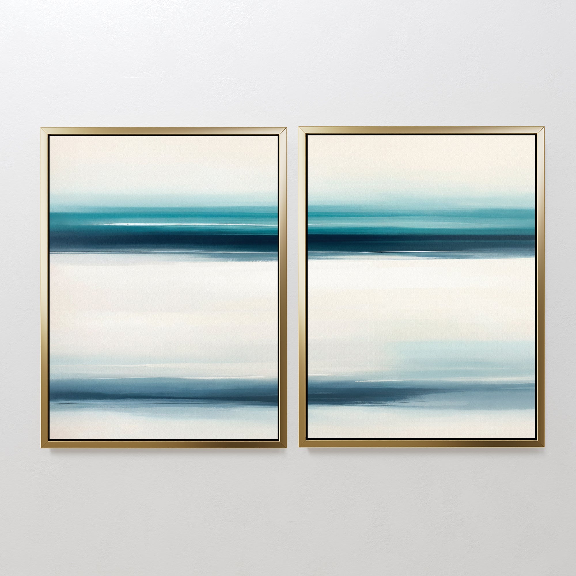 The Ocean Motion - Set Of 2 features abstract prints with horizontal blue, teal, and white bands in gold frames, adding serene sophistication and a coastal decor style to any plain white wall.