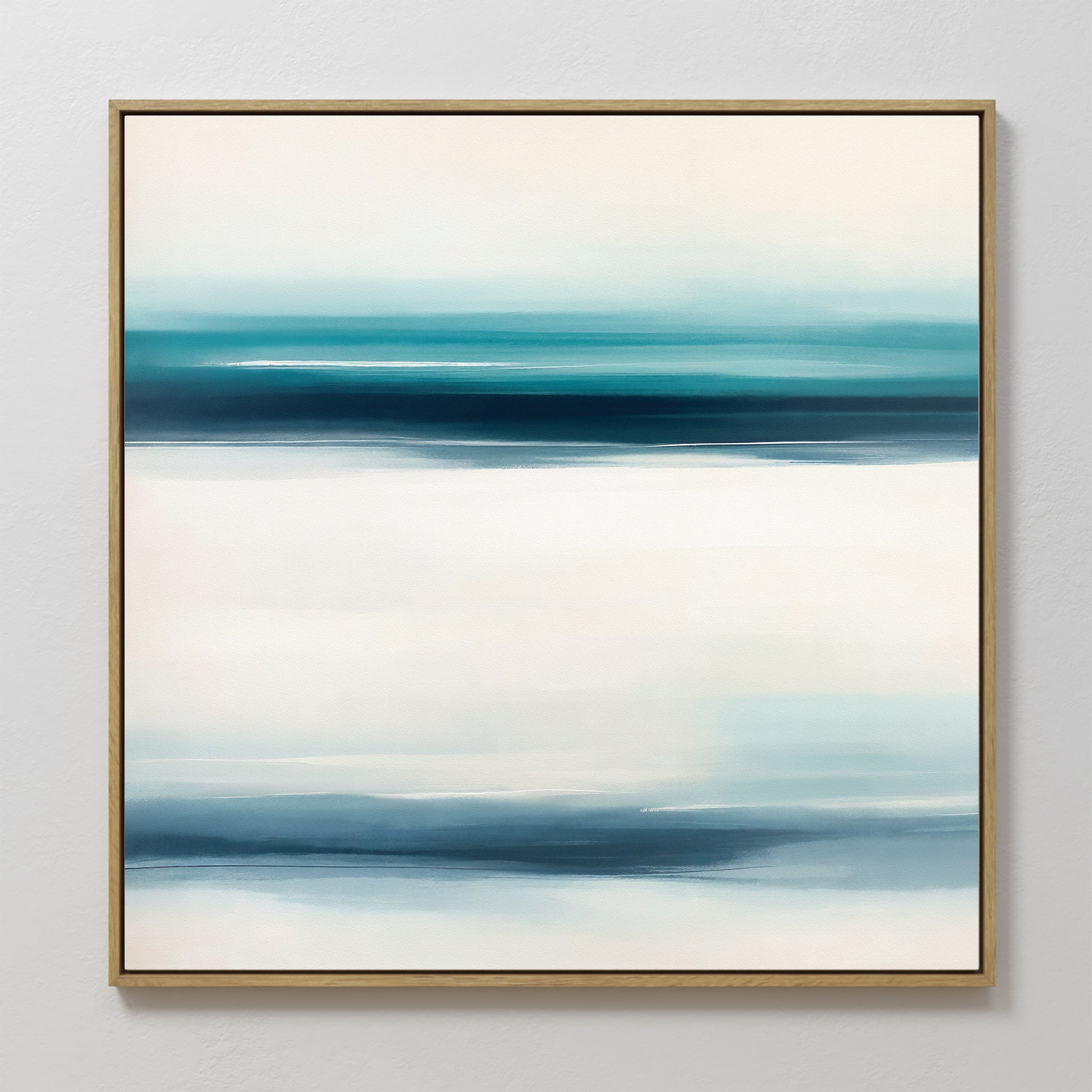 The Ocean Motion Canvas Art - Square showcases a minimalist abstract design with soft blue, teal, and white bands, framed in thin gold for a serene and sophisticated touch on any light-colored wall.