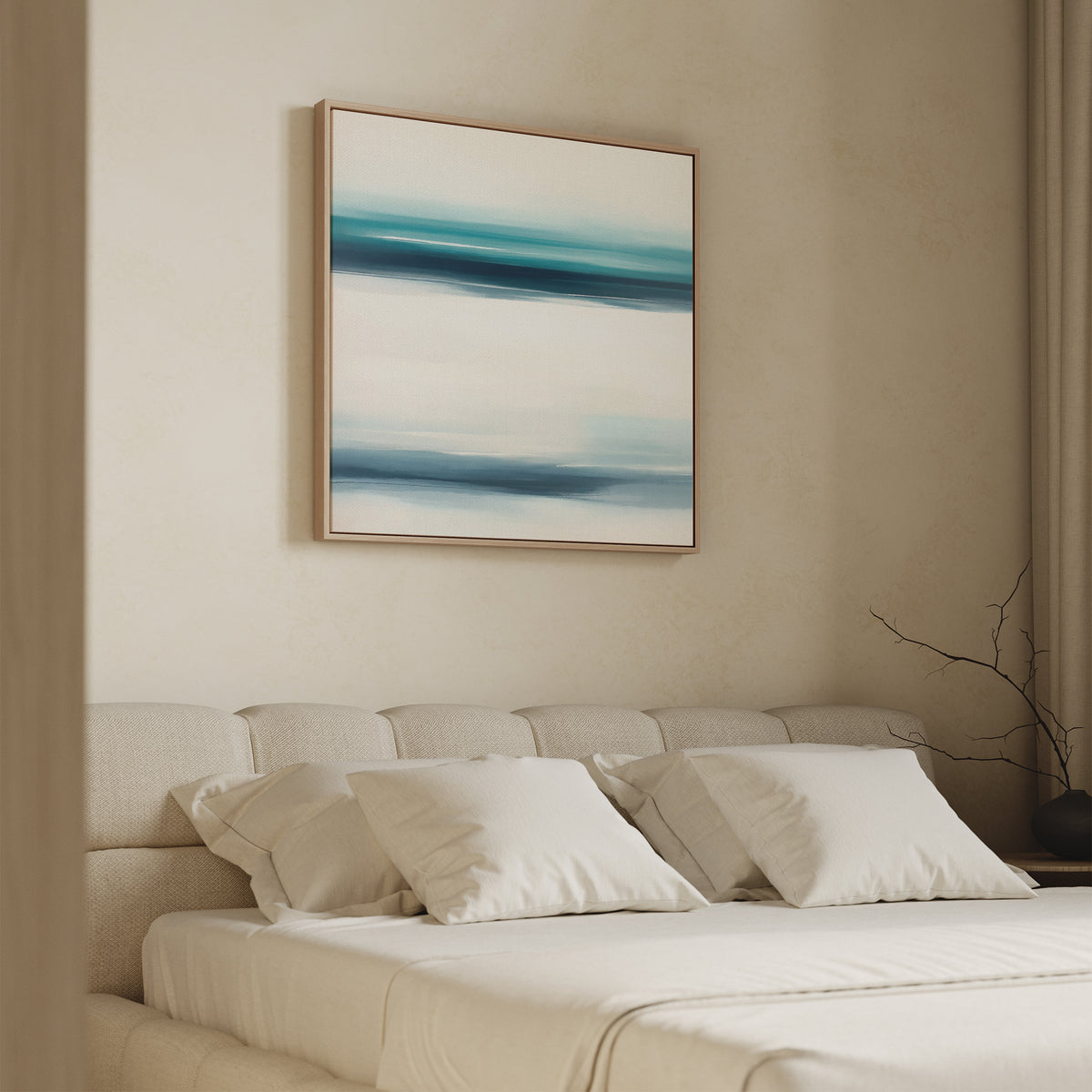 A modern bedroom features a beige upholstered bed with white bedding and pillows. Above, the Ocean Motion Canvas Art - Square showcases blue and teal brushstrokes, adding serene sophistication to the calm, minimalist space.