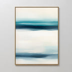 Ocean Motion Canvas Art - Vertical features an abstract print with teal, blue, and white horizontal bands for a serene, blurred landscape effect. Framed in slim gold, it brings sophisticated style to any coastal decor.