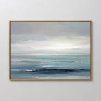 Ocean Swells Canvas Art - Horizontal: This framed print features a tranquil seascape with soft blue and gray tones, gentle waves, and an overcast sky, making it a serene piece of wall art for any light-colored room.