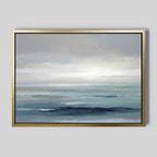 The Ocean Swells Canvas Art - Horizontal features a tranquil seascape in muted blue and gray tones, with soft waves and a cloudy sky, creating serene wall art that adds a peaceful ambiance to any room.