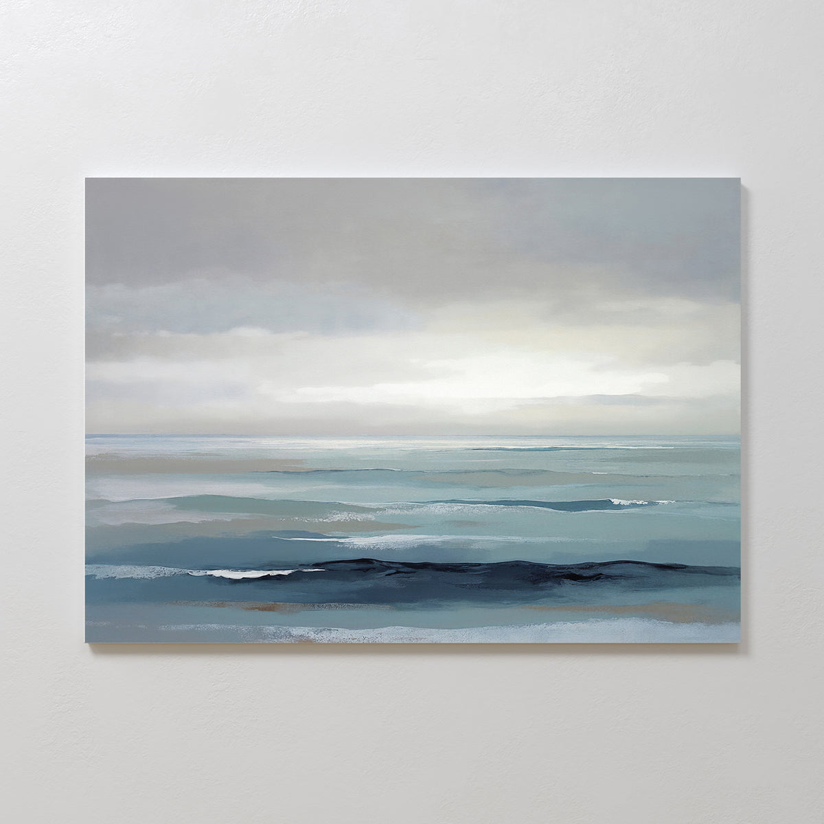 Ocean Swells Canvas Art - Horizontal features a calm seascape in soft blue and gray tones with gentle waves and a cloudy sky, creating a tranquil atmosphere—perfect as calming coastal wall art for any space.