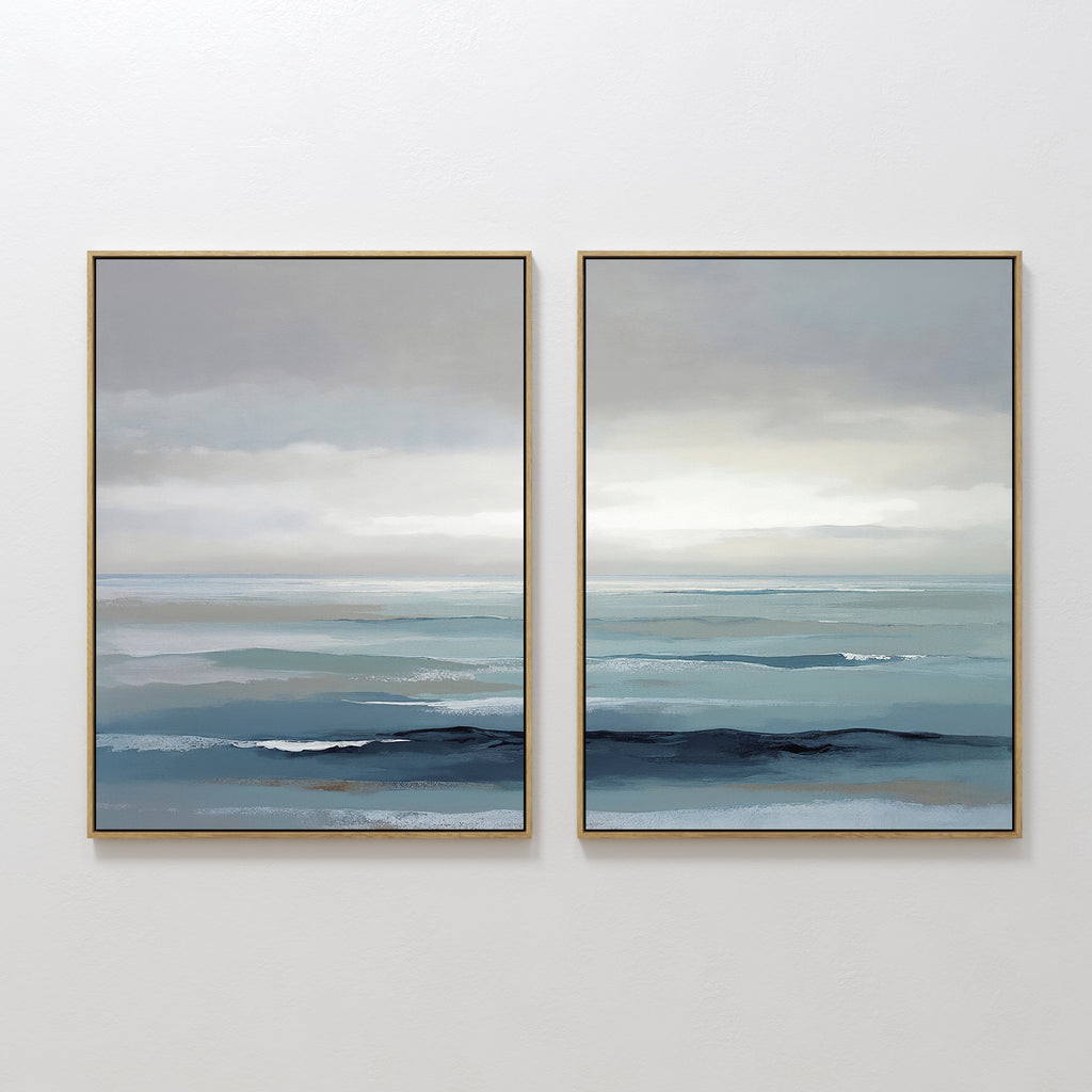 Ocean Swells - Set Of 2: Two framed prints featuring serene seascapes in soft blue, gray, and white tones—perfect coastal wall art for a peaceful, minimalist space.