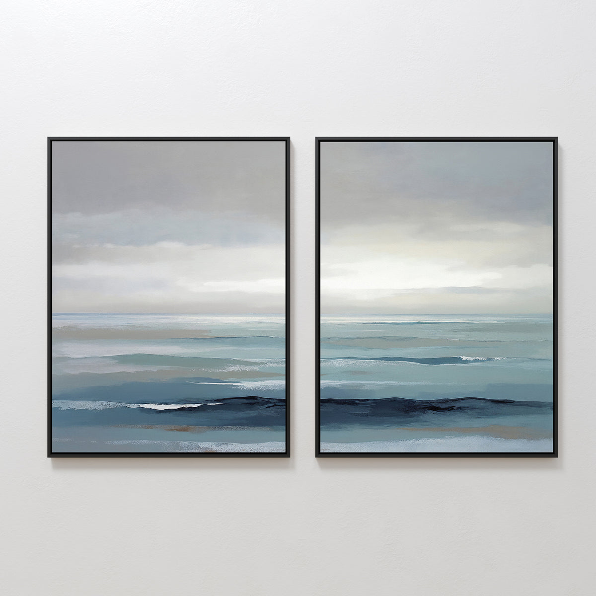 Ocean Swells - Set of 2 features framed prints of serene seascapes with calm blue water and cloudy gray skies. The minimalist coastal artwork adds a tranquil touch to any space, perfect as soothing wall decor.