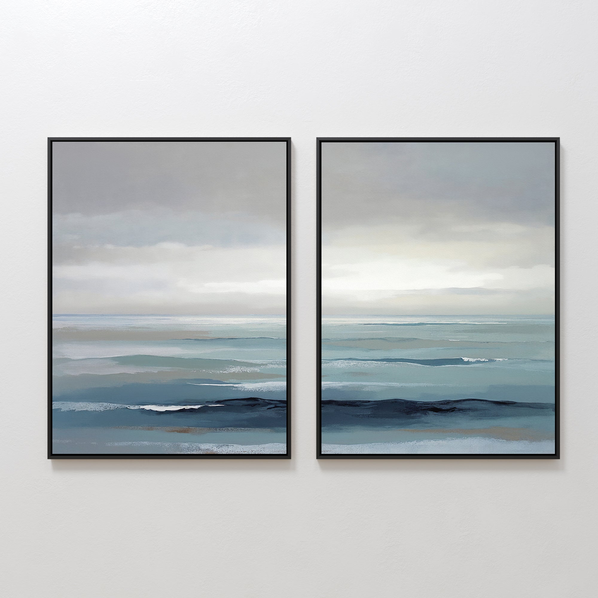 Ocean Swells - Set of 2 features framed prints of serene seascapes with calm blue water and cloudy gray skies. The minimalist coastal artwork adds a tranquil touch to any space, perfect as soothing wall decor.