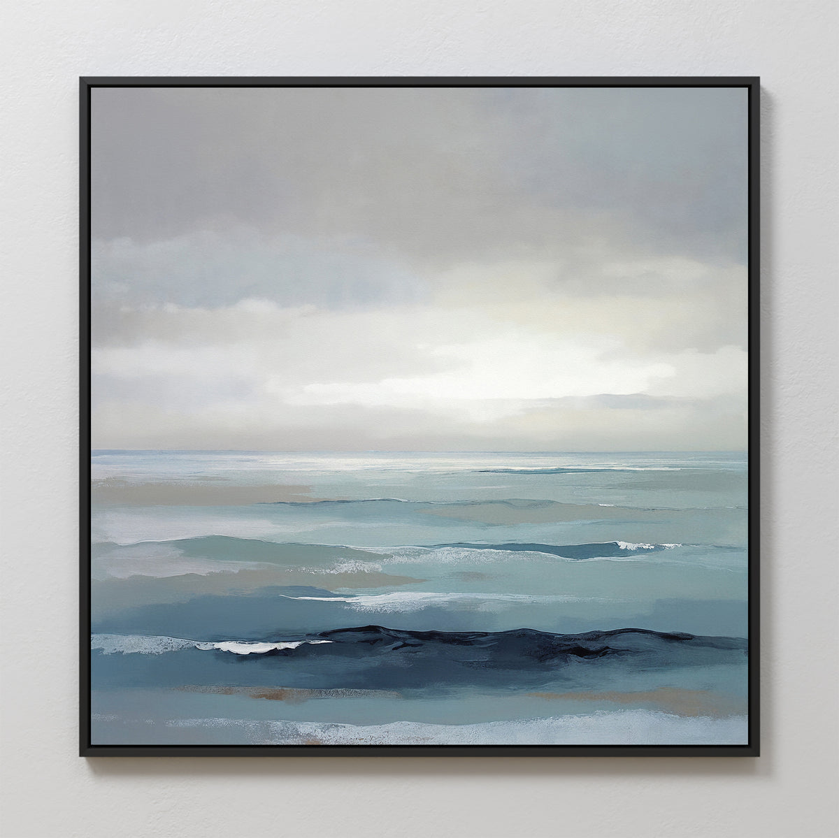 The Ocean Swells Canvas Art - Square features gentle waves in soft blue and gray under a cloudy sky, creating serene coastal wall art that hangs beautifully on a plain white wall.