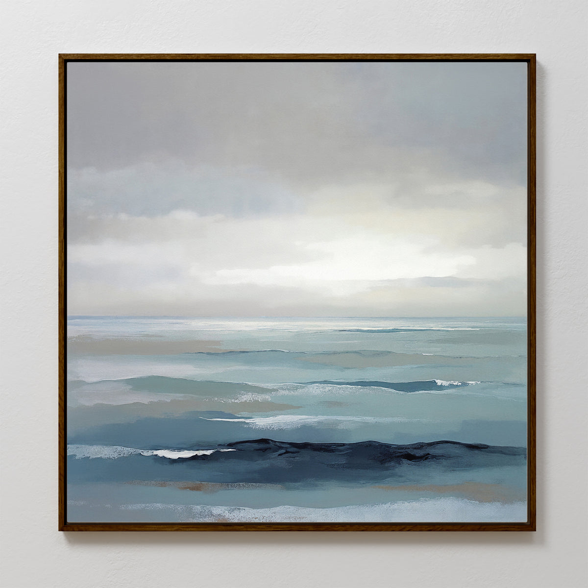 Ocean Swells Canvas Art - Square features an abstract coastal seascape in soft blue, gray, and white tones with gentle waves beneath a cloudy sky, creating serene wall art perfect for any white wall.