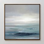 Ocean Swells Canvas Art - Square features an abstract coastal seascape in soft blue, gray, and white tones with gentle waves beneath a cloudy sky, creating serene wall art perfect for any white wall.