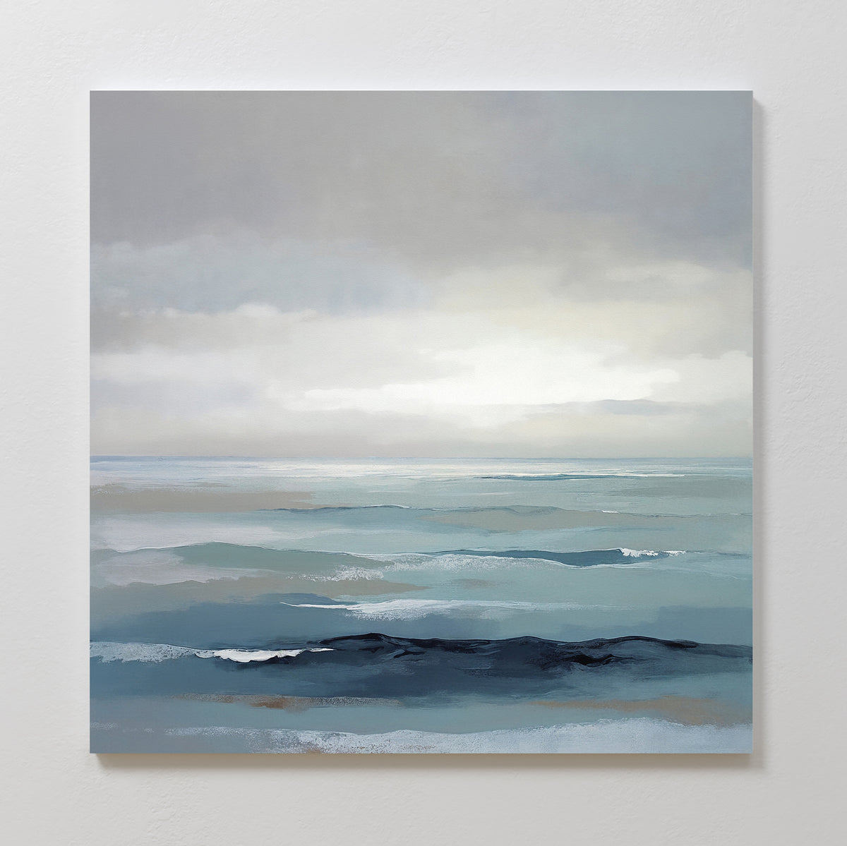 Ocean Swells Canvas Art - Square features a calm seascape in soft blue and gray tones with gentle waves and a cloudy sky, creating serene wall art ideal for tranquil spaces or Nordic Park-inspired decor.