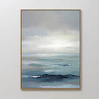 Ocean Swells Canvas Art - Vertical features a tranquil seascape with layered blues, soft waves, and a cloudy sky. This framed wall art brings a peaceful vibe to any Nordic Park-inspired space.