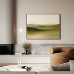 A modern living room with minimalist decor features a beige sofa, marble accents, a small round table with candles, a vase with dried branches, and the serene Pastoral Peace Canvas Art on the wall.