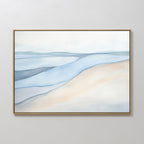 The Pale Currents Canvas Art - Horizontal features a minimalist abstract landscape with soft shapes in light blue, beige, and white, evoking water and sand under a pale sky. Elegantly framed with a thin gold frame for a calming touch to any space.