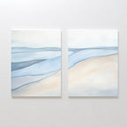 Pale Currents - Set of 2 features abstract canvas prints with soft blue, beige, and gray tones resembling water and sand under a pale sky—calming art ideal for minimalist or Nordic Park-inspired decor.