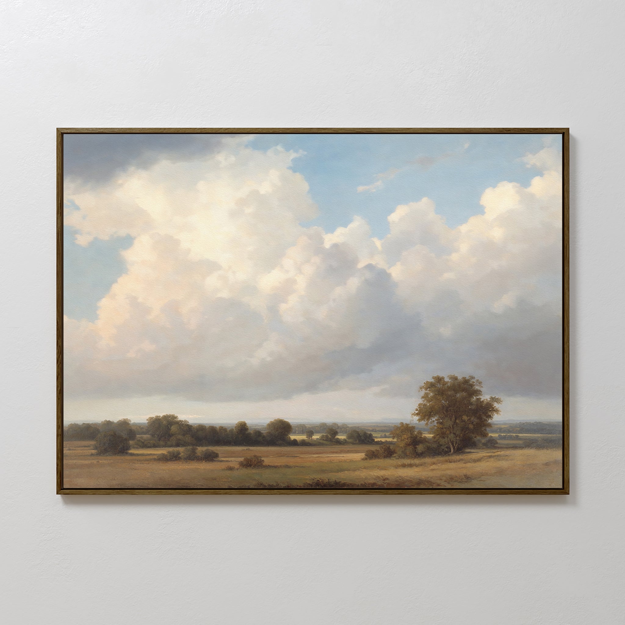 The Pastoral Grandeur Canvas Art - Horizontal features a serene open field with scattered trees and fluffy clouds, creating tranquil countryside wall art that adds an expansive, calming atmosphere to any room.