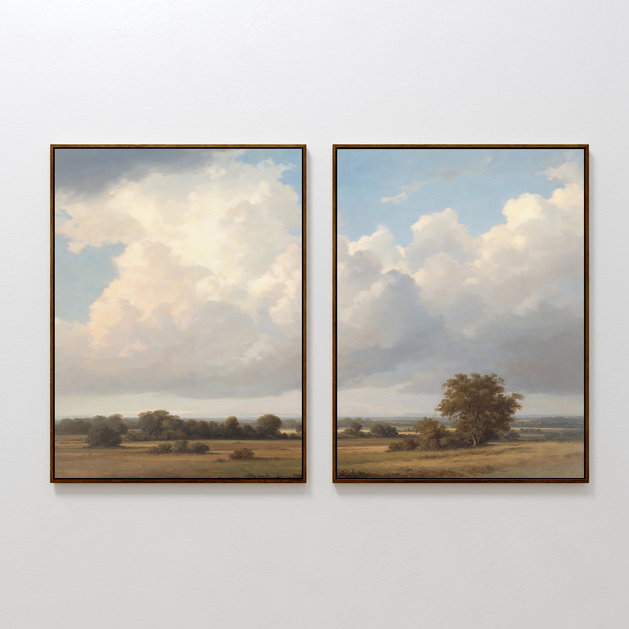 Two framed paintings from "Pastoral Grandeur - Set of 2" hang side by side, displaying Nordic-inspired open fields, scattered trees, and a cloud-filled sky—ideal countryside landscape wall art for any space.