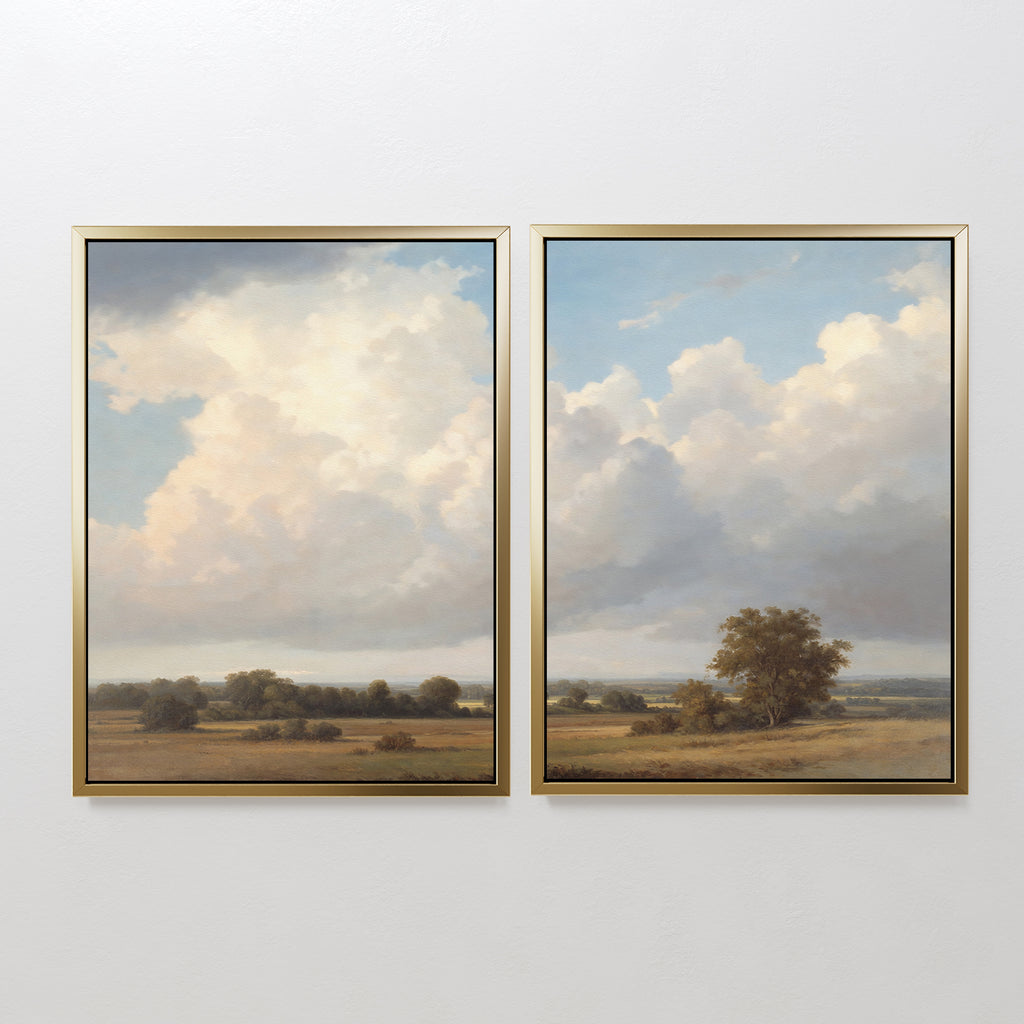 The "Pastoral Grandeur - Set of 2" features framed countryside landscape paintings with expansive skies, fluffy clouds, and open fields dotted with trees for a serene, pastoral touch to your decor.