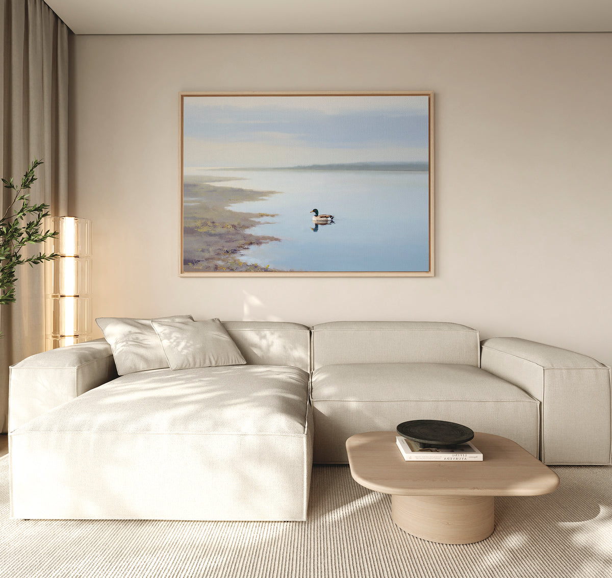 A modern living room with a light beige sectional, wooden coffee table, and the Peaceful Duck Haven Canvas Art - Horizontal above the sofa. Neutral tones and natural light capture Nordic Park’s calm in this tranquil space.