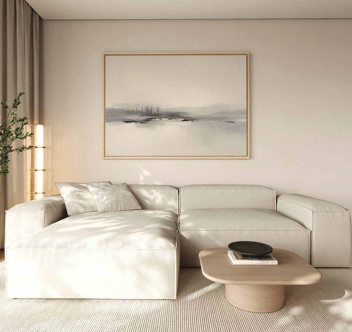 Minimalist living room with a light beige sectional, low wooden coffee table with a black bowl, and Peaceful Lake Morning Canvas Art - Horizontal on the wall. A tall plant in the corner and neutral tones create a calm atmosphere.