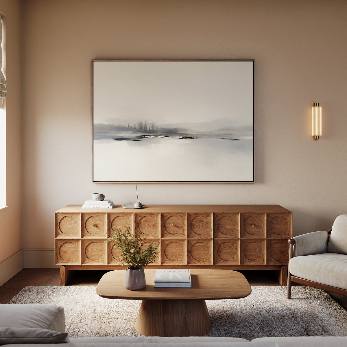 A minimalist living room with a wooden sideboard, light sofa, low wooden coffee table, textured rug, and the Peaceful Lake Morning Canvas Art - Horizontal above the sideboard creates a peaceful atmosphere.
